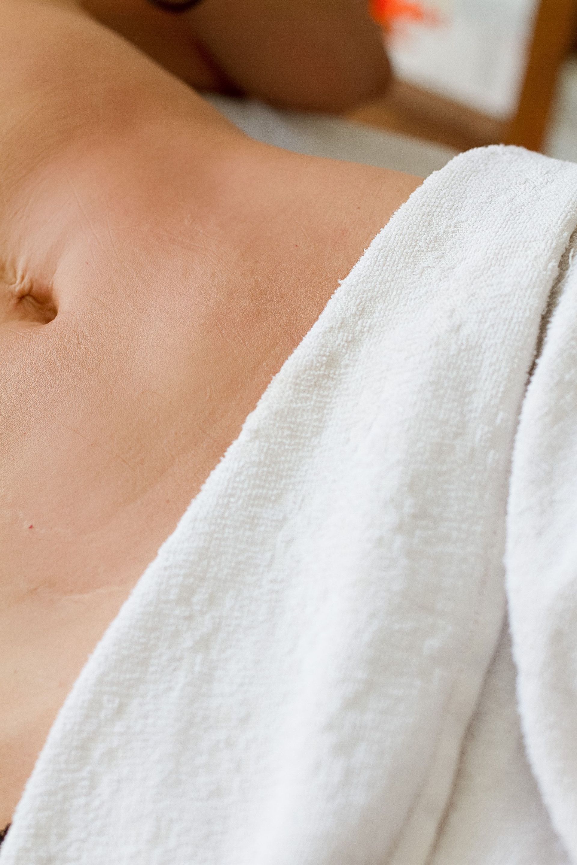 Close-up of a person relaxing with a towel during a spa treatment, highlighting skin and relaxation.